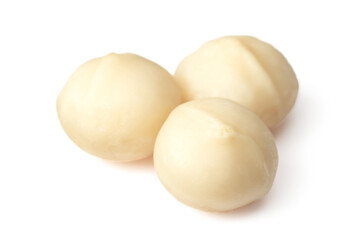 Unshelled macadamia nuts isolated on white background.