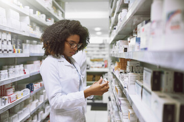 This isnt suppose to be here. Shot of a focused young female pharmacist walking around and doing...