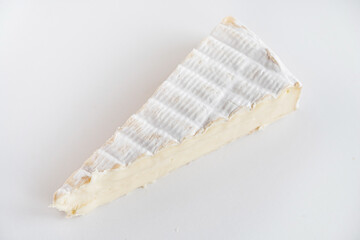 Cut pieces of whole and sliced camembert cheese