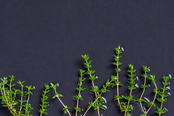 Thyme leaves on black table background, herbs