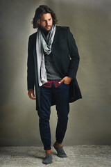 Fashion changes, style endures. Shot of a stylishly dressed man posing against a gray background in...