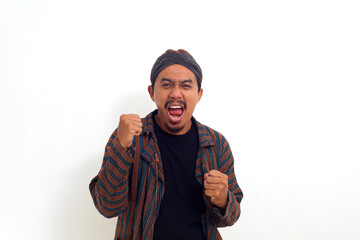 Excited asian young man in java traditional costume. Isolated on white background