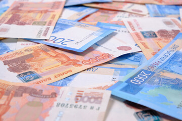 Background, Russian rubles banknotes in denominations of two and five thousand rubles.