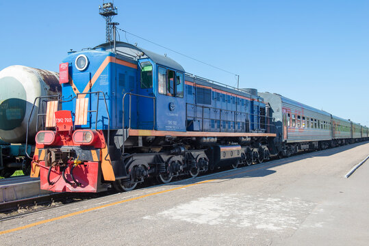 VELIKIE LUKI, RUSSIA - JULY 04, 2018: Soviet/Russian shunting locomotive TEM2-7617 with a passenger train on a sunny July day. Velikiye Luki Station