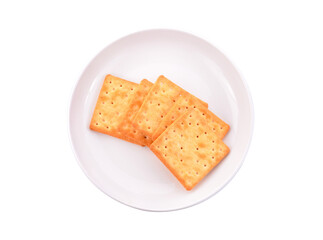 Thin crispy biscuits in a plate isolated on white background. Top view.