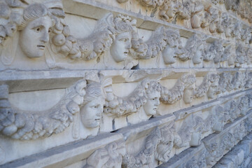 Many marble faces carved into the historical wall. Afrodisias, Geyre/Aydın/Turkey