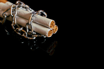 Nicotine addiction. Three cigarettes rewound by a chain 
