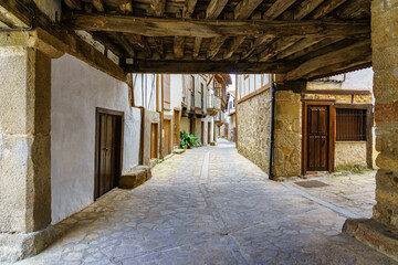 Old village arcades with traditional wooden roof, Salamanca Spain.