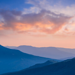 mountain ridge silhouette in blue mist at the twilight, natural mountain landscape