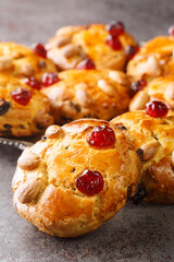 Yorkshire Fat Rascals delicious scone like cake, flecked with citrus and spice and filled with juicy raisins closeup in the plate on the table. Vertical