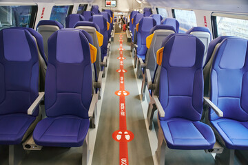 Modern high speed train interior with empty blue seats