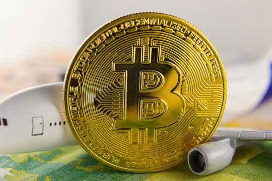 airplane and bitcoin stand on euro banknotes close-up - Powered by Adobe