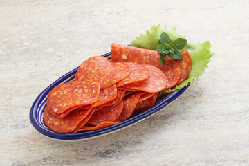Sliced pepperoni sausage in the bowl