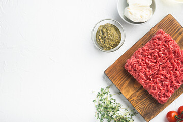 Fototapeta na wymiar Raw meatballs made from ground beef ingredients, on white stone background, top view flat lay, with copy space for text