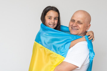 Fototapeta premium elderly man and girl with the flag of Ukraine