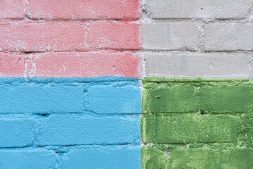 Green, pink, grey and blue brick wall texture background. Geometric, square pattern on house wall. Creative, stylish backdrop. Painted stone structure. Close up, copy space - Powered by Adobe