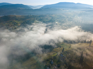 Morning mist in Ukrainian Carpathian mountains. Aerial drone view.