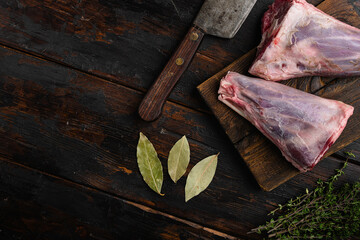 Raw lamb shanks meat, on old dark  wooden table background, top view flat lay, with copy space for...