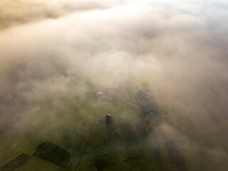 Morning mist in Ukrainian Carpathian mountains. Aerial drone view.