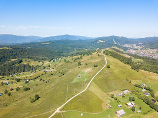 Green mountains of Ukrainian Carpathians in summer. Sunny clear day. Aerial drone view.