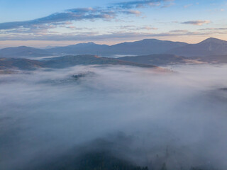 Sunrise over the fog in the Ukrainian Carpathians. Aerial drone view.