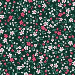 Beautiful vintage pattern. 
 small white and pink flowers, green leaves. Dark green background. Floral seamless background. An elegant template for fashionable prints.