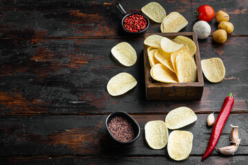 Crispy potato chips, on old dark  wooden table , with copy space for text