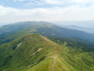 Fototapeta premium High mountains of the Ukrainian Carpathians in cloudy weather. Aerial drone view.