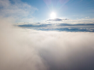 High flight above the clouds. Aerial drone view.