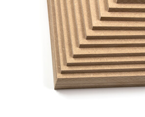 Brown MDF boards, arranged in a pyramid shape. They can be used in the furniture industry and the construction industry.