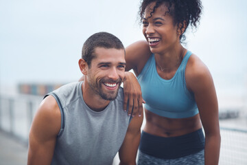 The journey were taking has been so rewarding. Shot of a sporty young couple taking a break while exercising outdoors. - Powered by Adobe