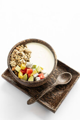 granola muesli healthy breakfast bowl with yogurt and tropical fruit