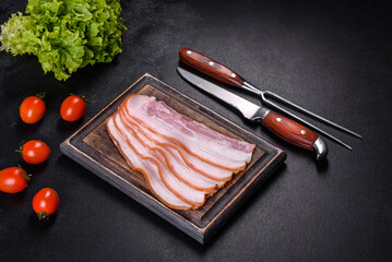 Slices of bacon on a wooden cutting Board. Pork meat