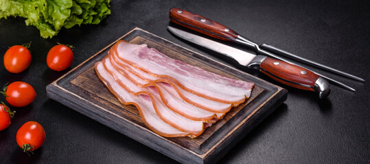 Slices of bacon on a wooden cutting Board. Pork meat