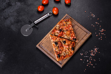 Homemade vegetable pizza with addition of tomatoes, olives and herbs