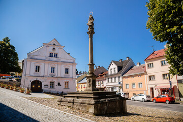 Becov nad Teplou, Czech Republic, 14 August 2021: colorful buildings in historic center in medieval city, baroque houses on main town May 5 square, Marian Column near city hall at sunny summer day