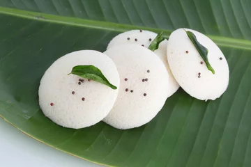 Fotobehang Idly , Idli is a traditional breakfast of South India served on banana leaf © SMD IMAGES