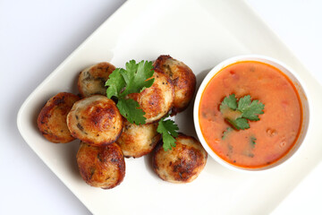 Kuzhi Paniyaram served with coconut chutney and sambar- South Indian breakfast