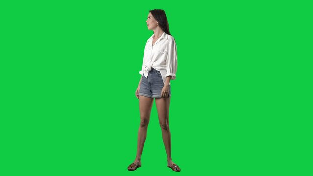 Amazed and fascinated young stylish woman looking around. Shopping sale concept. Full body isolated on green screen background