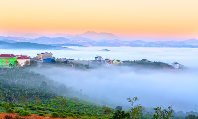 Morning landscape in a small town blurred in the morning mist with dawn sky background is peaceful in highlands Da Lat, Vietnam