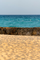 Sea and sandy shore with a fence. Beautiful sea horizon