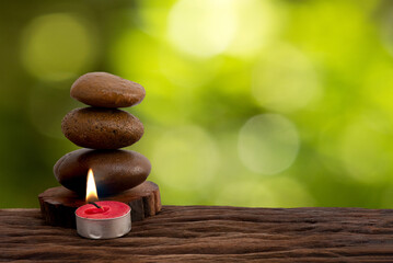 Obraz na płótnie Canvas Zen stones and candle on nature background.