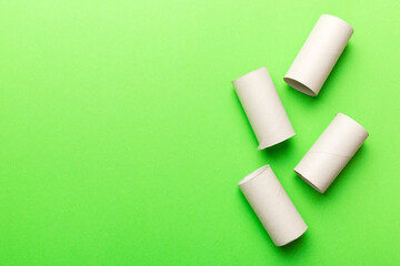 Flat lay composition with empty toilet paper rolls and space for text on color background. Recyclable paper tube with metal plug end made of kraft paper or cardboard