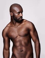 Looking good and he knows it. Studio shot of a muscular african american man posing isolated on...
