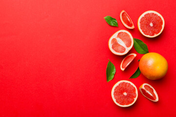 fresh Fruit grapefruit with Juicy grapefruit slices on colored background. Top view. Copy Space. creative summer concept. Half of citrus in minimal flat lay with copy space