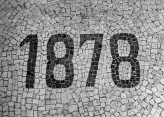date of construction building, 1878. mosaic on ancient building floor.