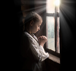 Girl at the window on a black background