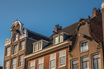 Fototapeta na wymiar Amsterdam, Netherlands, April 2022. Historic facades along the canals of Amsterdam.