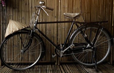 An old bike parked in a storage shed with light shining down on it. Retro classic vintage bicycle concept.