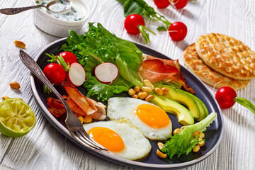 fried eggs, lettuce, avocado, radish, peanuts, ham